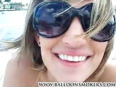 Hot teen Cheyenne smoking a cigarette on boat topless.